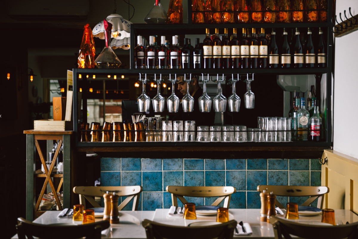 Apulia bar area with wine glasses and blue tiles